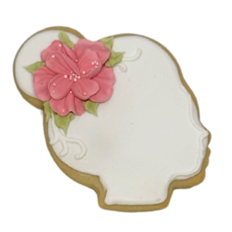 Mother's Day cookie shaped like a woman's profile with a pink flower.