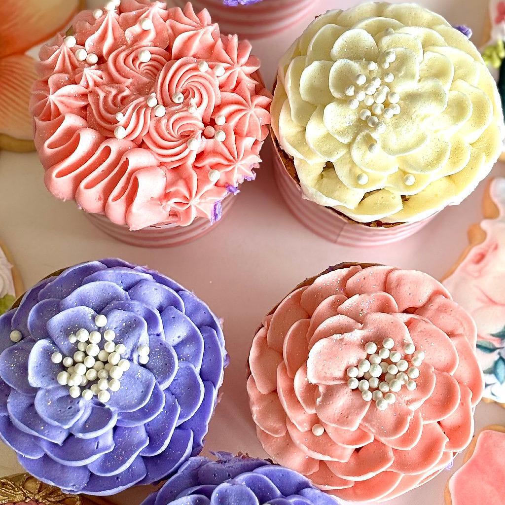 Mother's Day cupcakes with floral piped frosting and pearls.