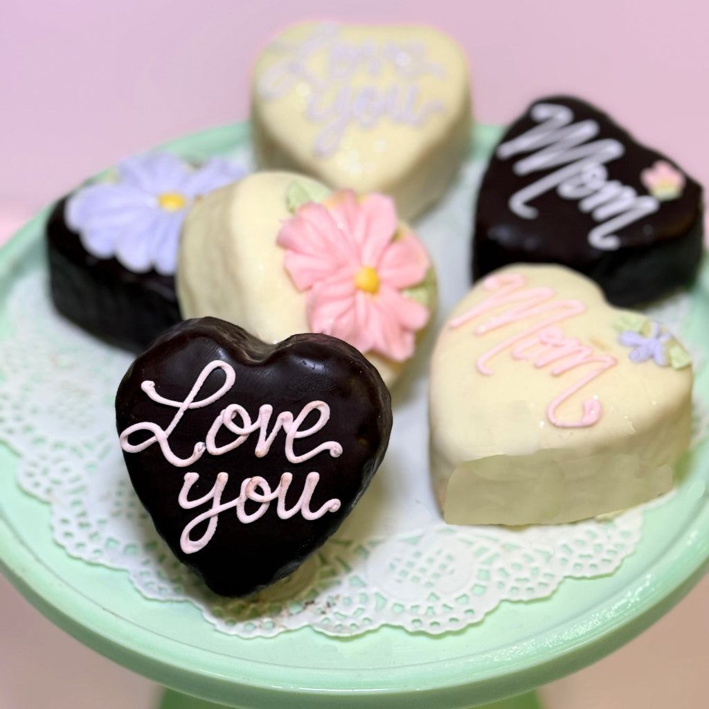 Mother's Day heart-shaped petit fours on a green cake stand.