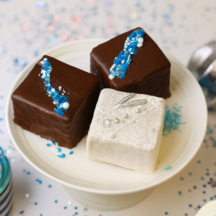 Hanukkah petit fours with blue and silver festive decorations.