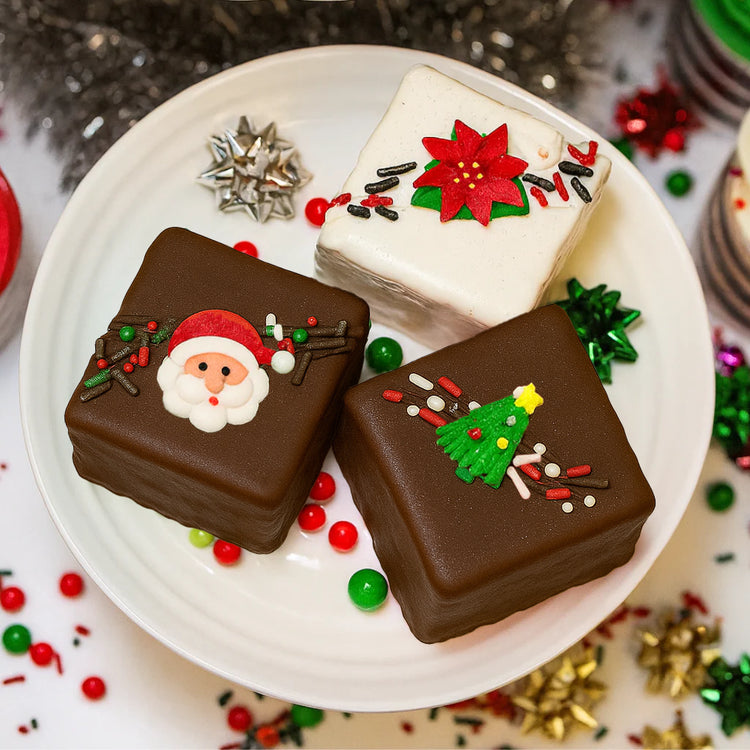 Christmas Petit Fours decorated with Santa, tree, and poinsettia.