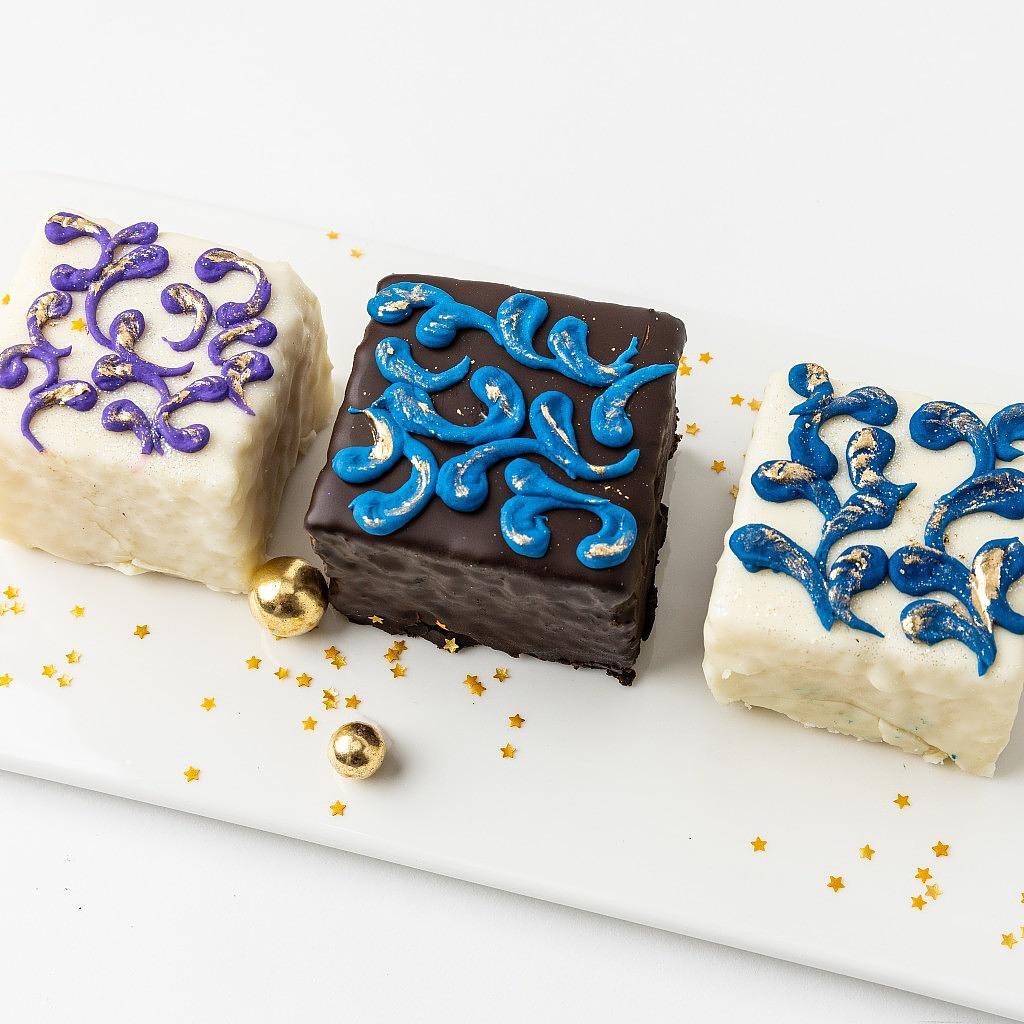 Ramadan & Eid Petit Fours with blue and purple icing on a tray