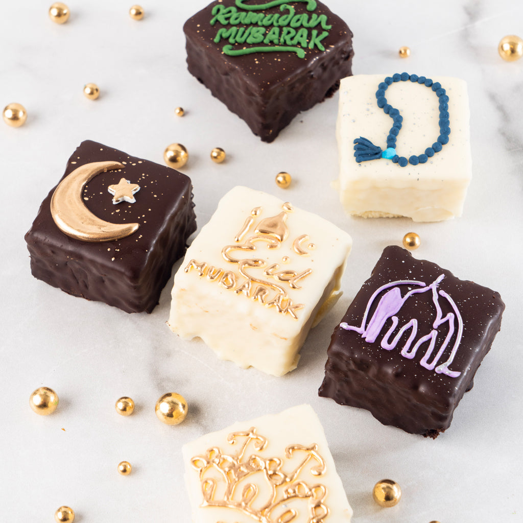 Ramadan & Eid petit fours with festive icing on marble.