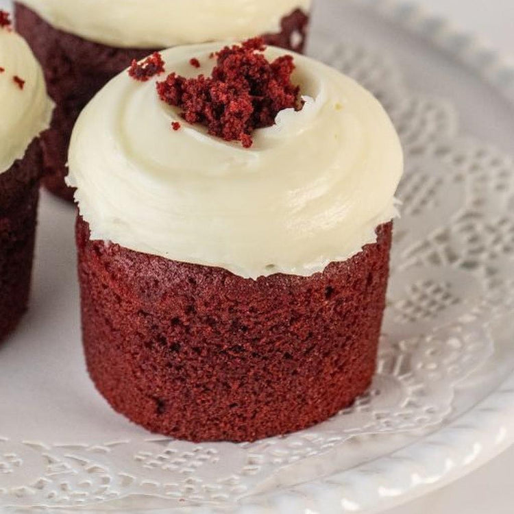 Assorted red velvet cupcakes with white cream frosting
