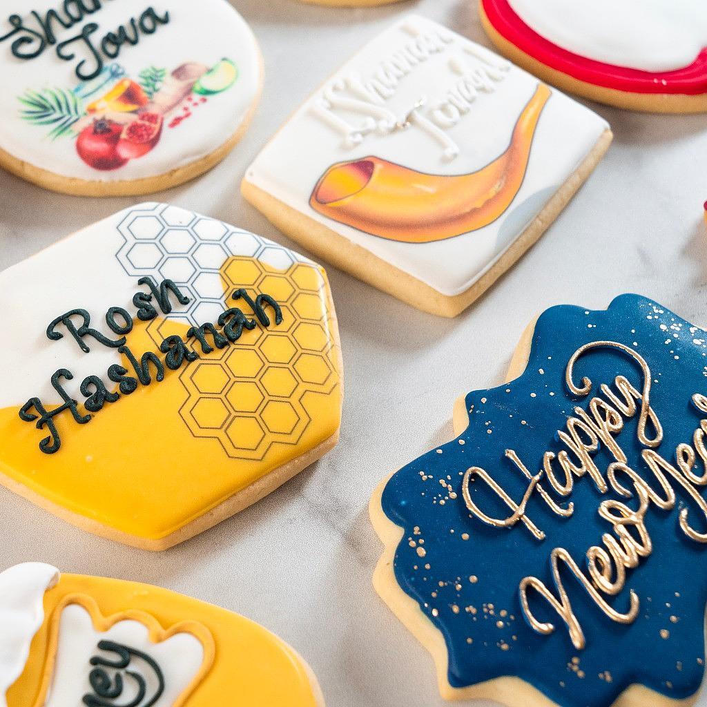 Assorted Jewish High Holidays cookies with festive icing designs.