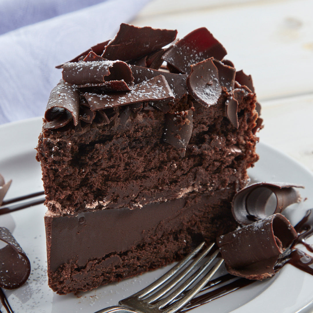 Cosmic birthday cake slice topped with dark chocolate curls.