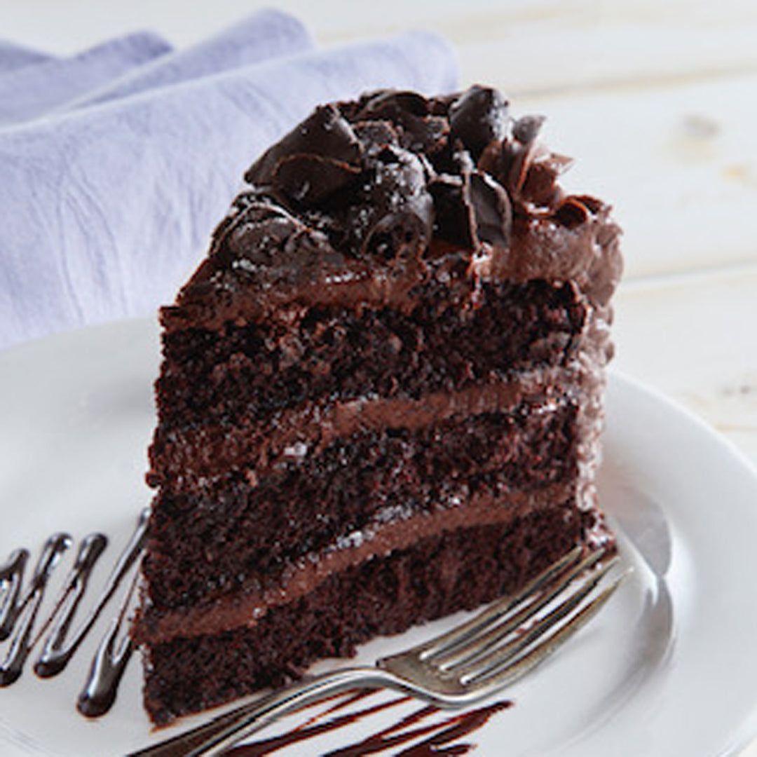 Mom's Chocolate Cake slice with chocolate shavings on a plate.