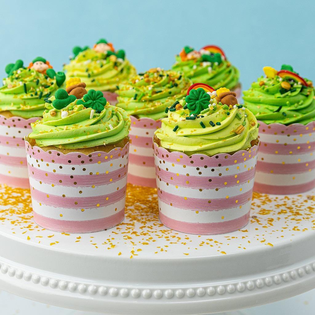 St. Patrick's Day cupcakes with green frosting in striped cups