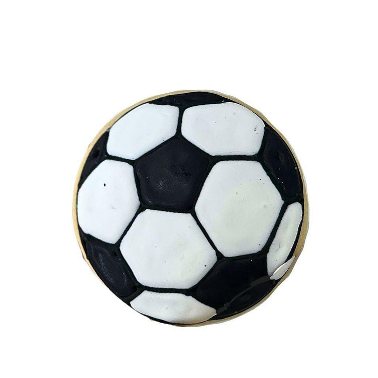 Soccer cookie with black and white hexagonal icing pattern.
