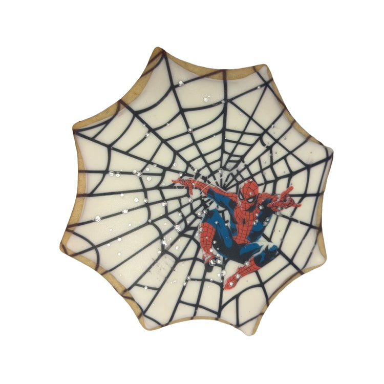Spiderman cookie with white icing and black web design.