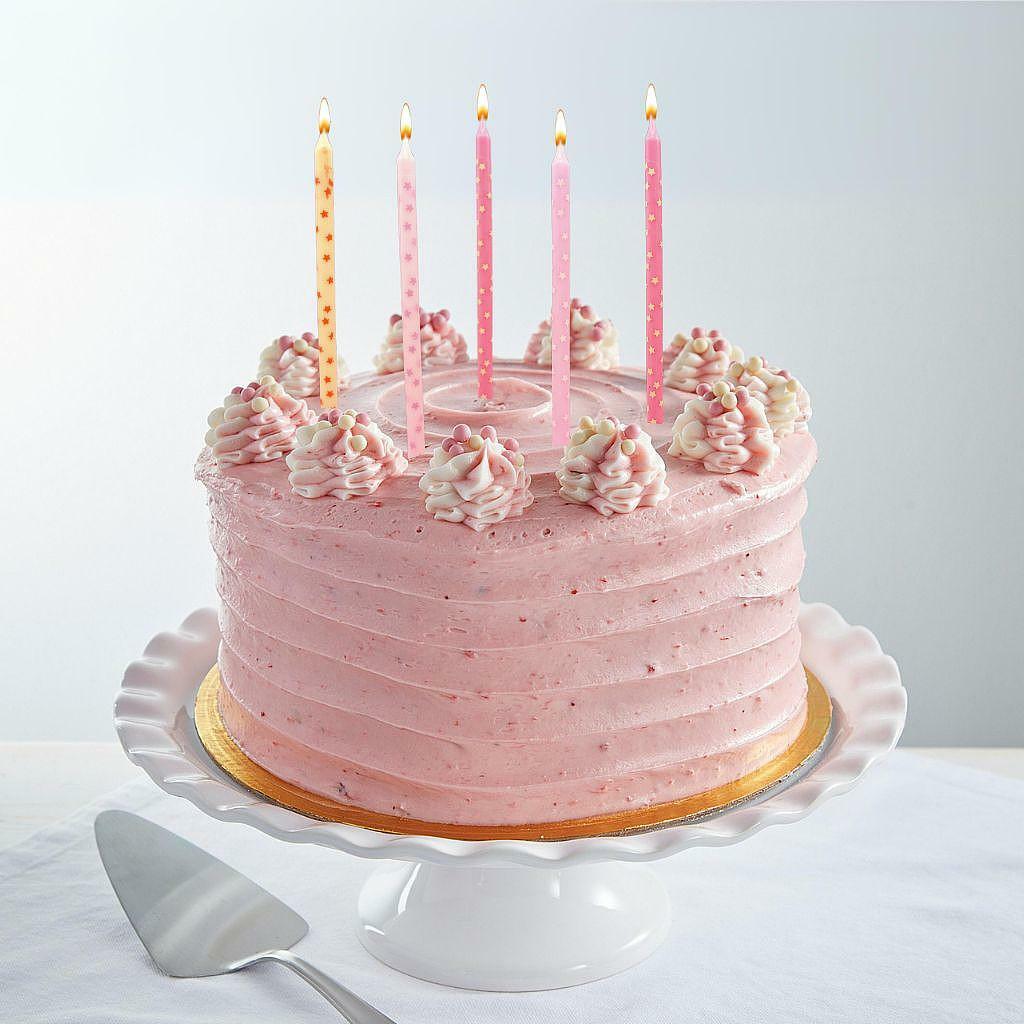 9-inch Strawberry Dream Cake with pink frosting and candles.