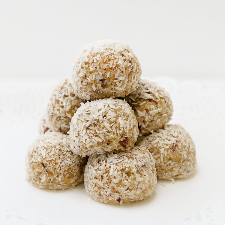 Cranberry pistachio snowballs coated in shredded coconut.