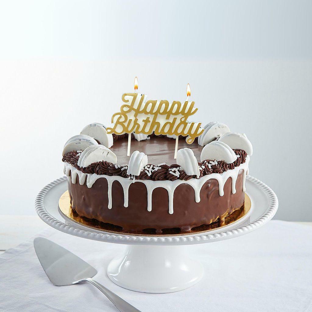The Big "O" 9-inch chocolate cake with white drip and macarons