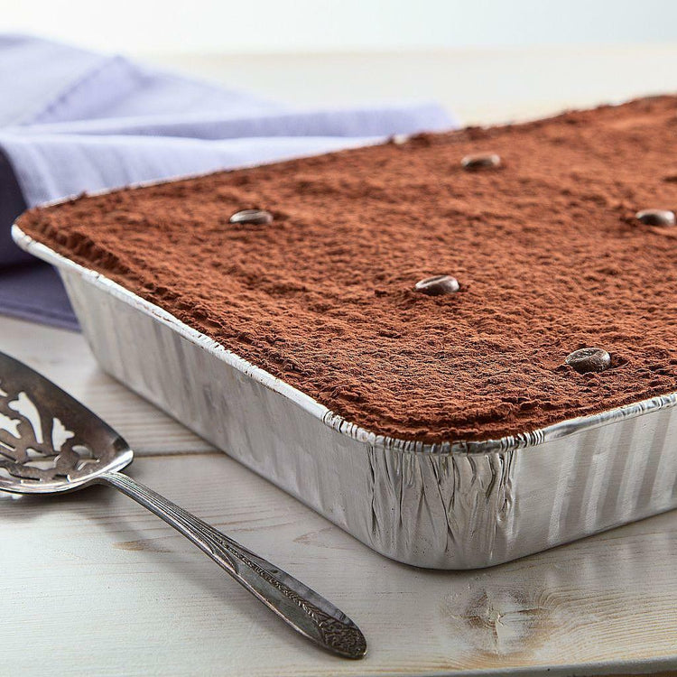 Tiramisu in a 13x9 aluminum pan topped with coffee beans.