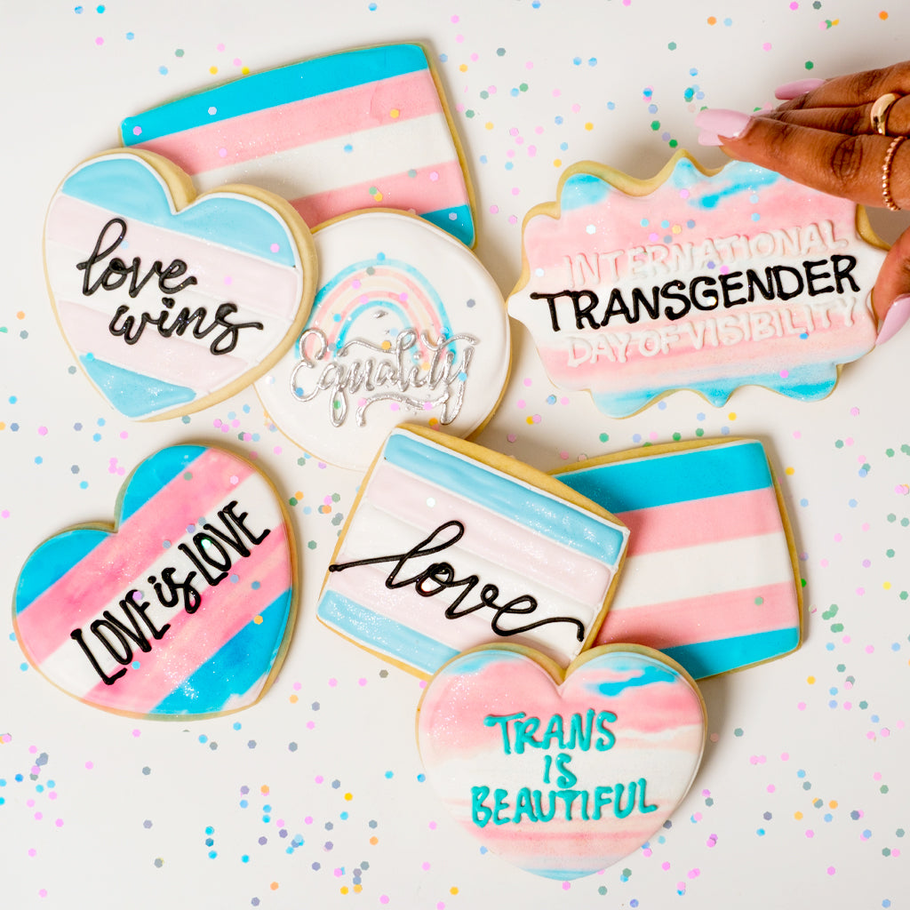 Trans Day of Visibility cookies with pink, blue, and white icing.