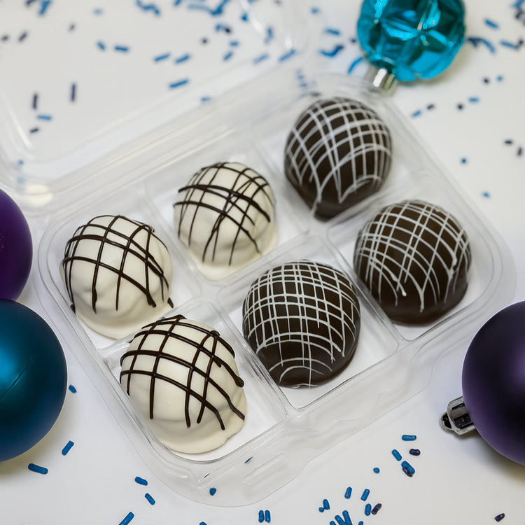 Peanut Butter & Oreo truffles in a clear plastic gift box.