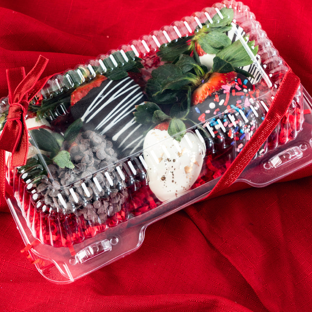Gift box of 6 chocolate-dipped strawberries with red ribbon.