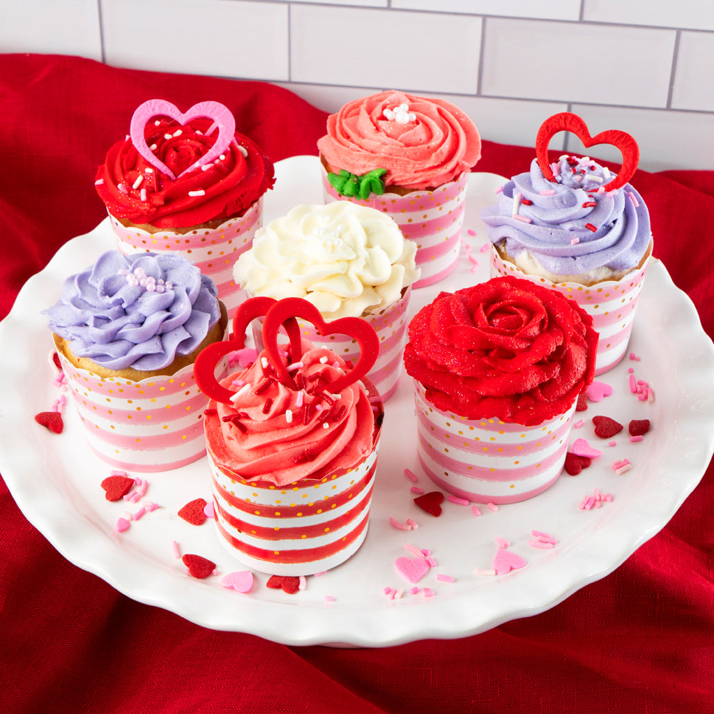 Valentine cupcakes with red, pink, and purple rose frosting.