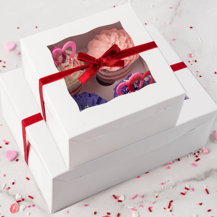 Valentine's Day cupcake collection in white boxes with red ribbon.