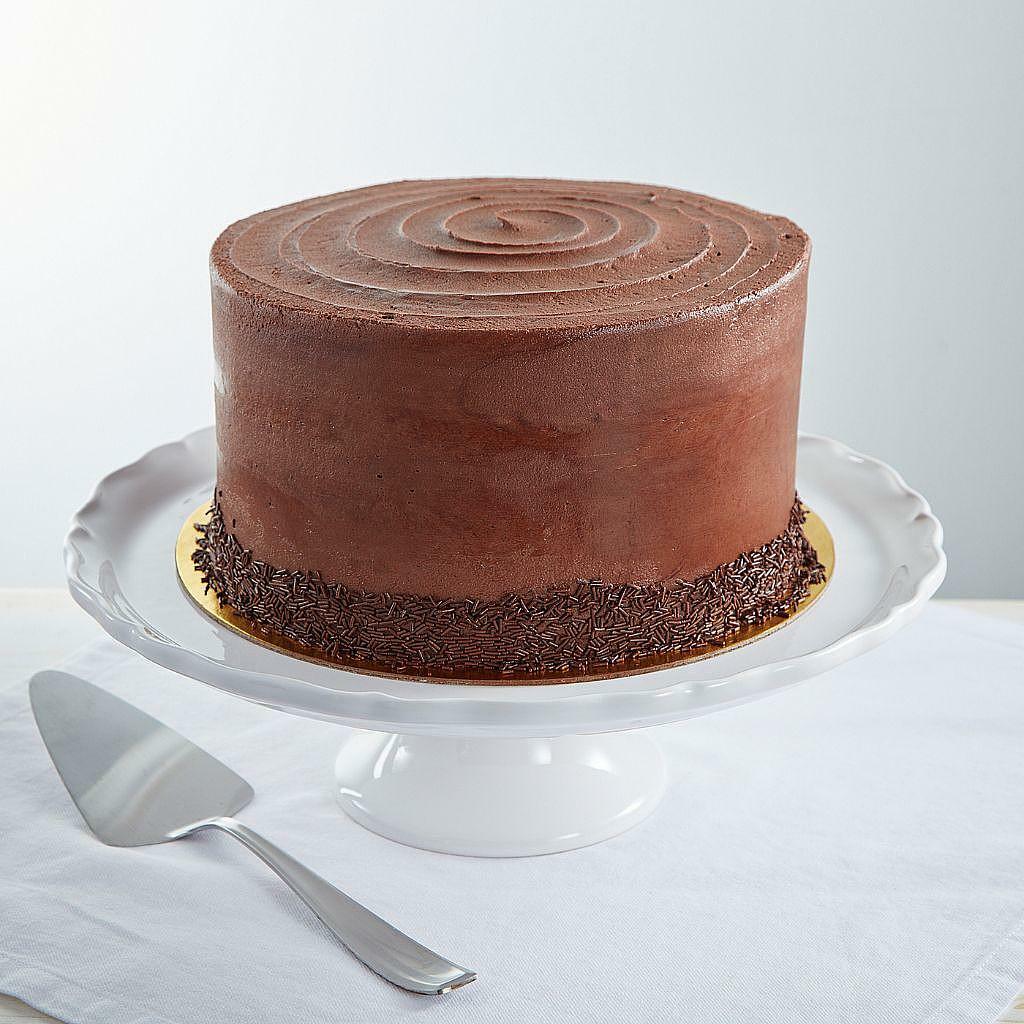 9-inch Vegan Mom's chocolate cake with sprinkles on a stand