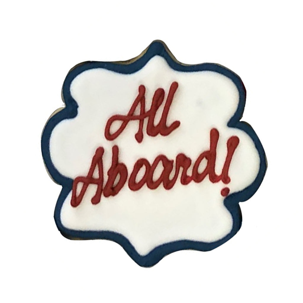 Train theme cookie with All Aboard text in red icing.