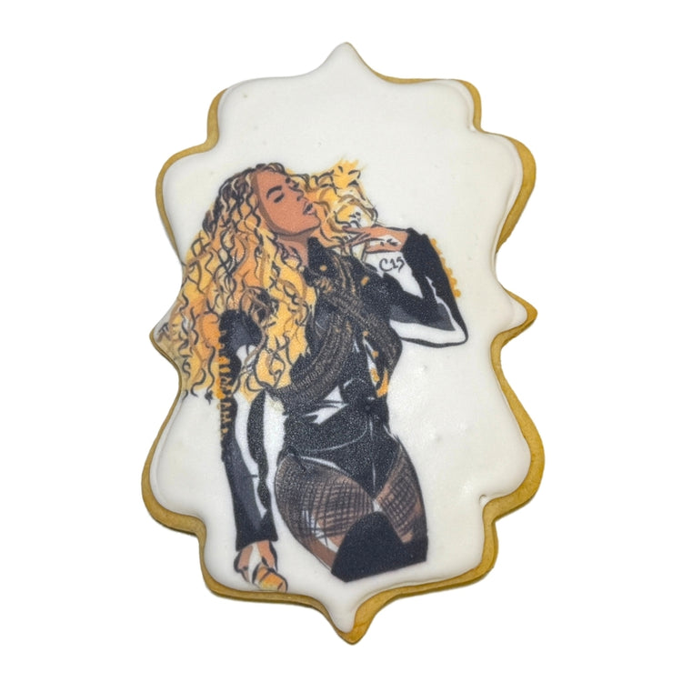 Beyoncé portrait on a scalloped sugar cookie with icing.