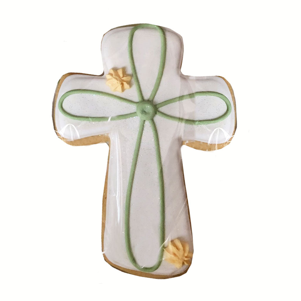 Contemporary Cross cookie with white icing and green piping.