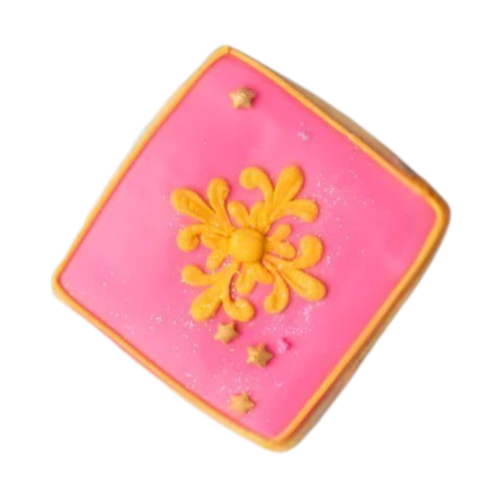 Square Diwali cookie with pink icing and yellow floral design.