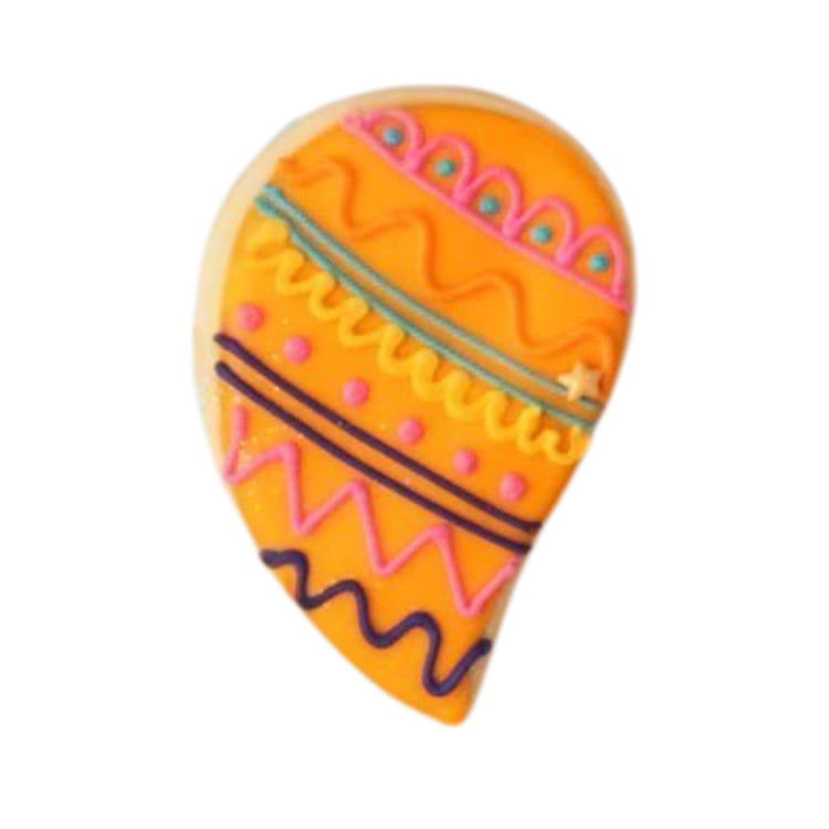 Diwali cookie with orange icing and colorful piped patterns.