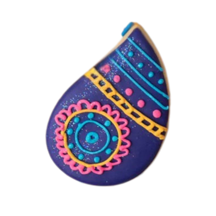 Diwali cookie in a purple paisley shape with colorful icing.