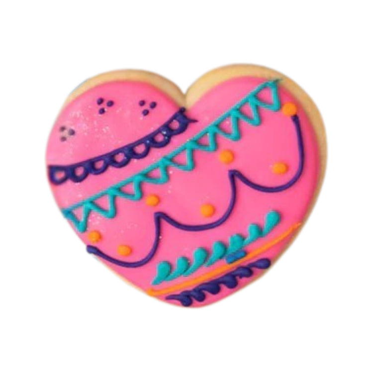 Heart-shaped Diwali cookie with pink icing and colorful patterns.