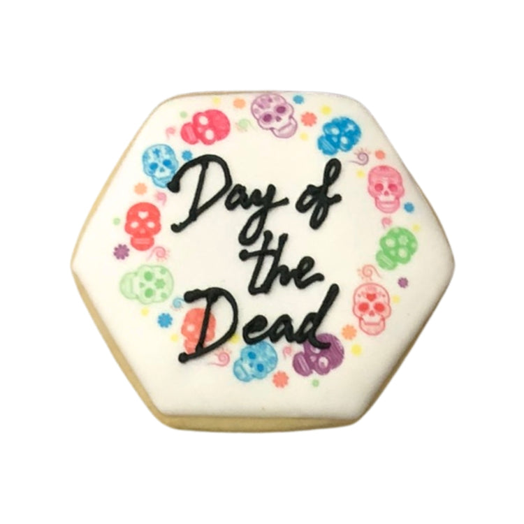 Hexagonal Day of the Dead cookie with colorful skull icing.