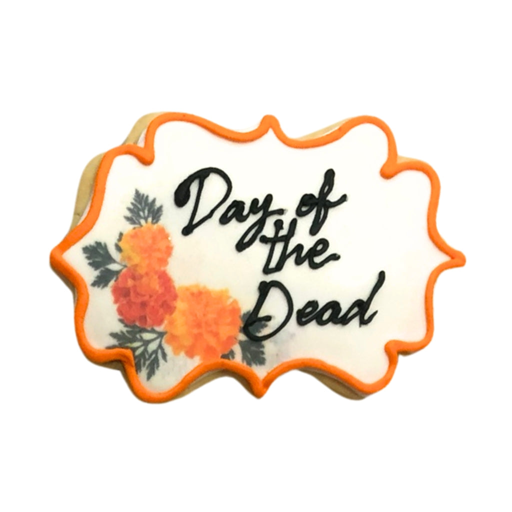 Day of the Dead cookie with orange marigold floral icing.