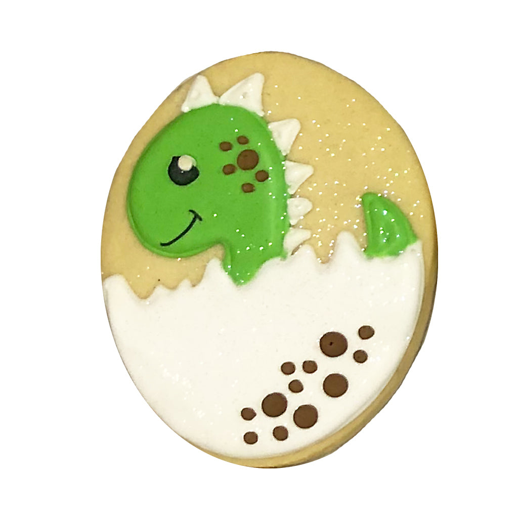 Dino hatching cookie with green dinosaur in a white egg.
