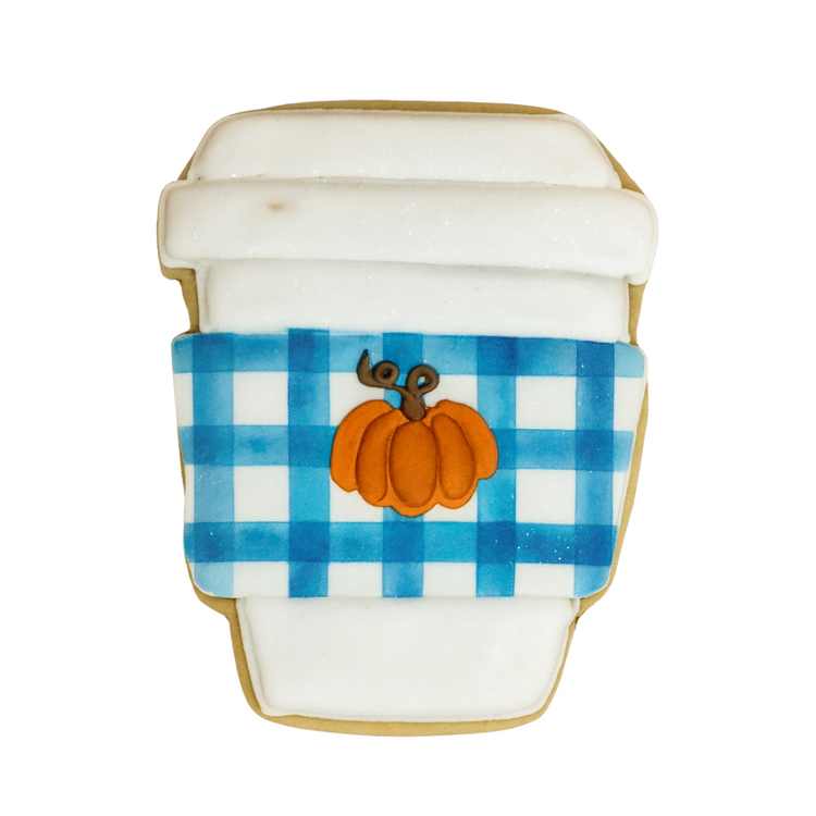 Fall cookie shaped like a coffee cup with a blue plaid sleeve.