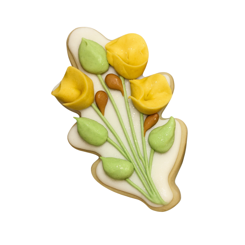 Fall cookie decorated with yellow flowers and green leaves.