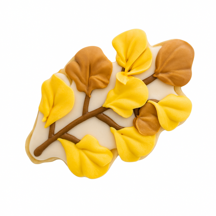 Fall cookie shaped like a branch with yellow and brown leaves.