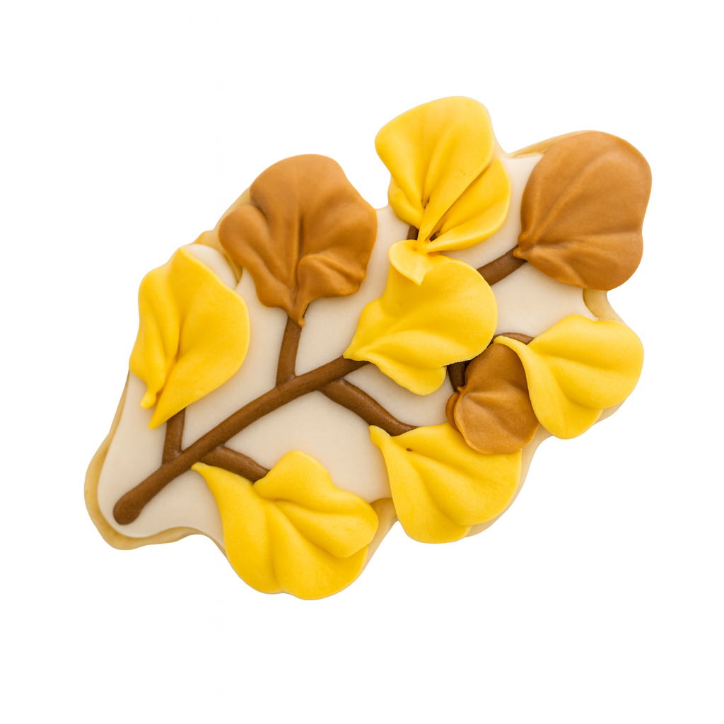 Fall cookie shaped like a branch with yellow and brown leaves.