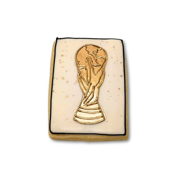World Cup cookie with a gold trophy design on white icing.