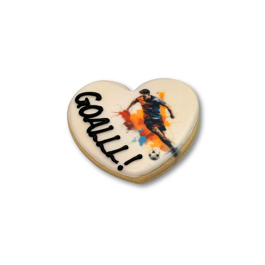 Heart-shaped World Cup cookie with GOAL! text and soccer player.