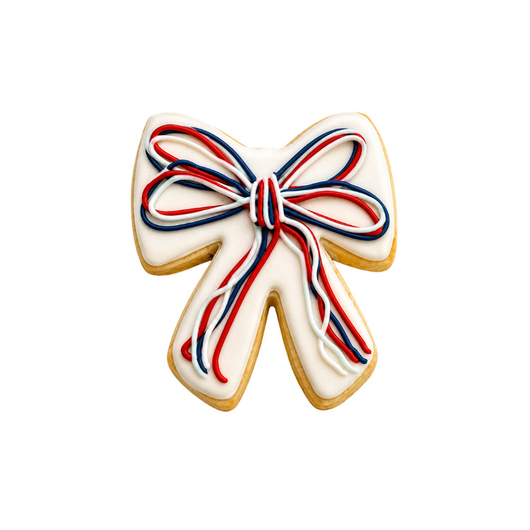 4th of July bow-shaped cookie with red, white, and blue icing