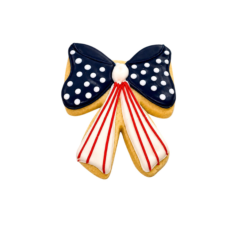4th of July bow-shaped cookie with red, white, and blue icing
