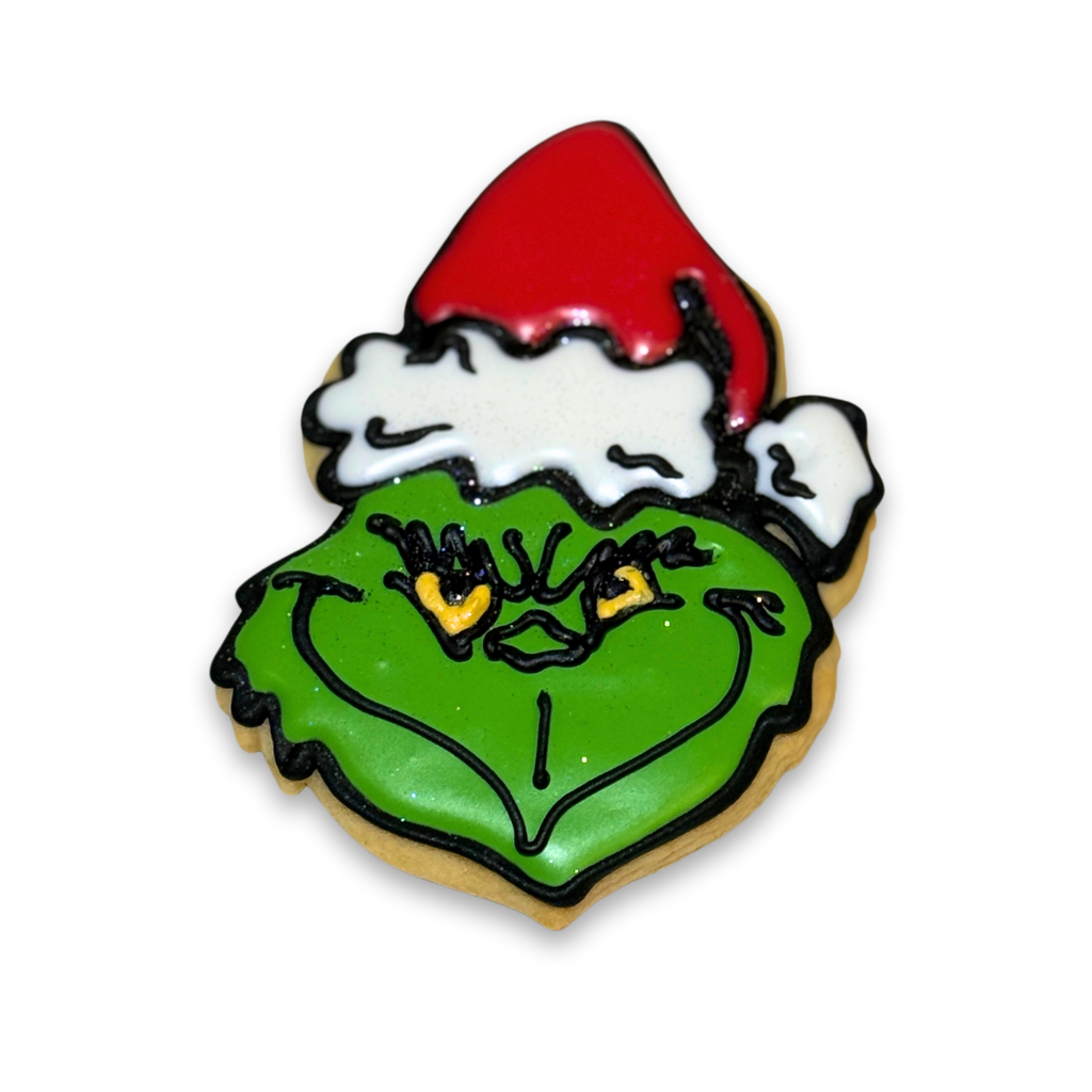 Merry Grinchmas character cookie with red Santa hat icing.