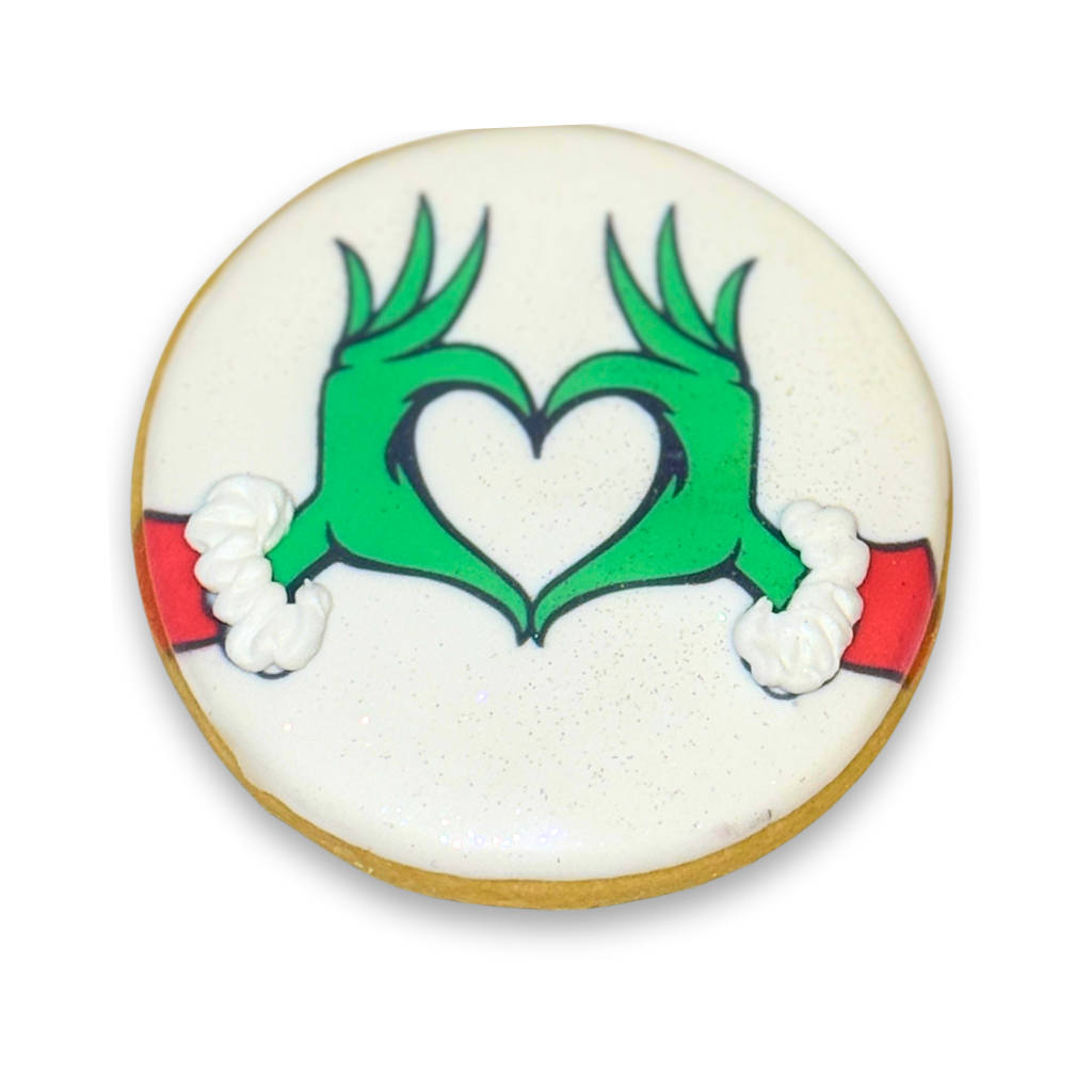Merry Grinchmas cookie with green hands forming a heart.