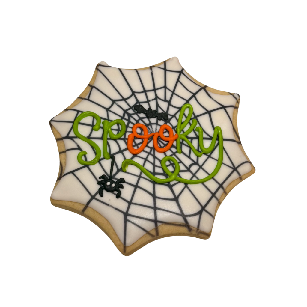 Halloween cookie shaped like a web with Spooky icing.