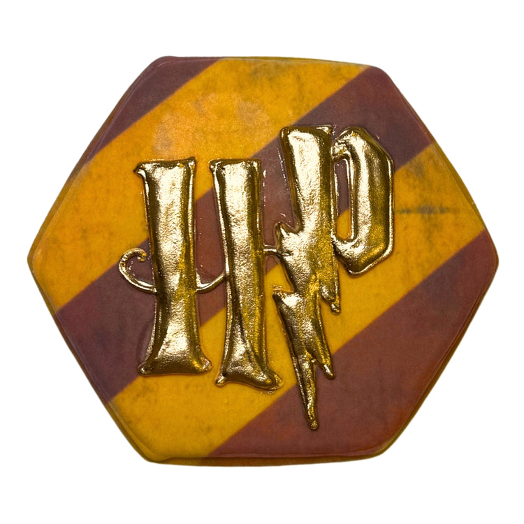 Harry Potter cookie with gold HP logo on striped maroon and gold.