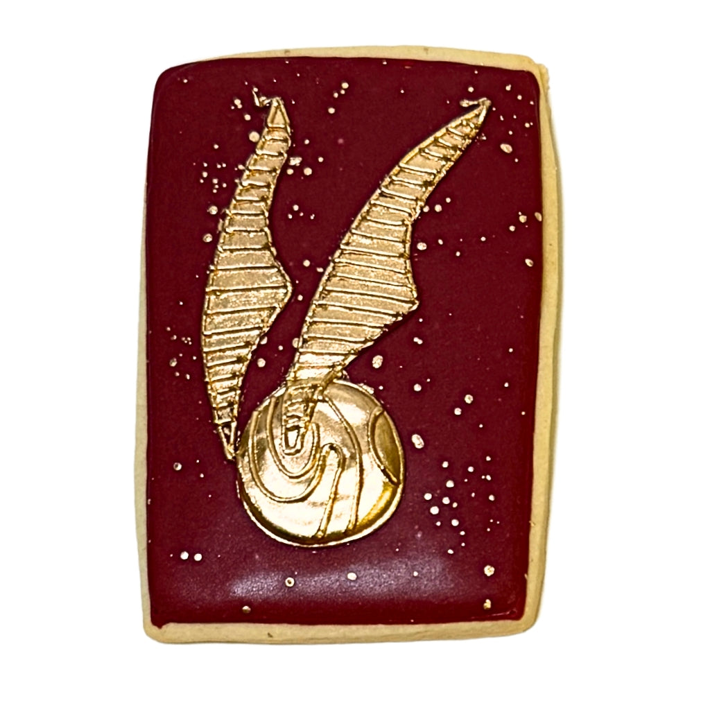 Harry Potter cookie with a gold snitch on maroon icing.