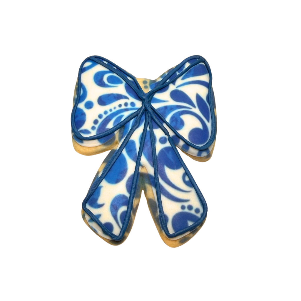 Hispanic Heritage bow-shaped cookie with blue floral pattern.