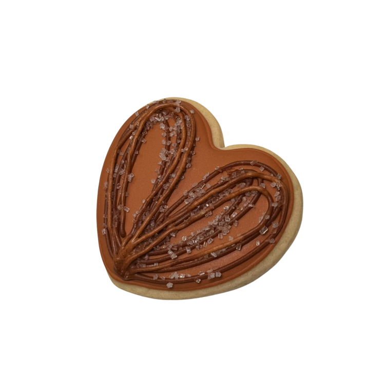 Hispanic Heritage heart-shaped cookie with brown icing.
