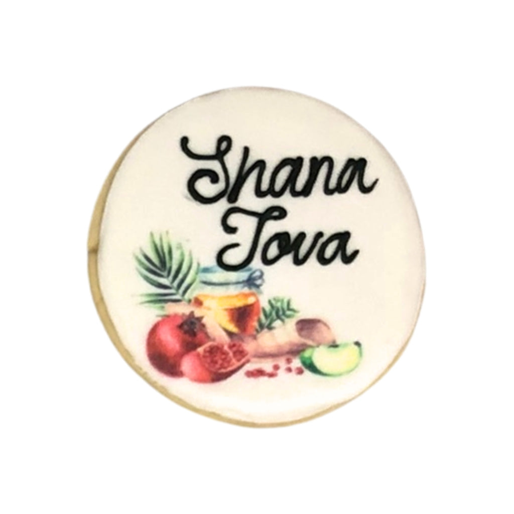 Jewish High Holidays cookie with Shana Tova text and fruit art.
